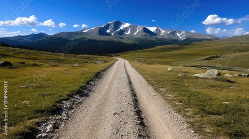 Mountainous dirt road leading to snowy peak