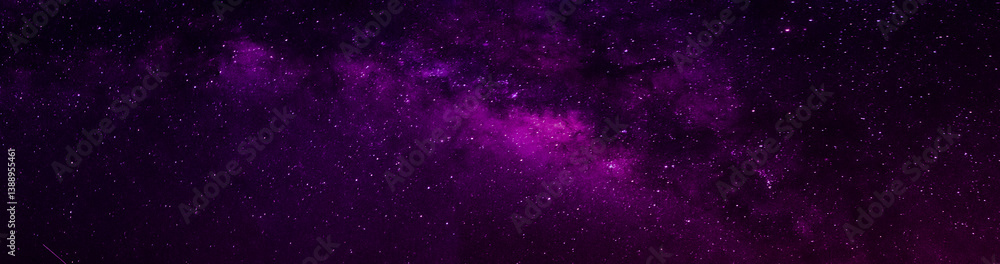 Milky way in night sky and stars on dark background with noise and grain. Long exposure and white balance. Panoramic photo. Milky way in night sky and stars on dark background with noise and grain. Long exposure and white balance. Panoramic photo.