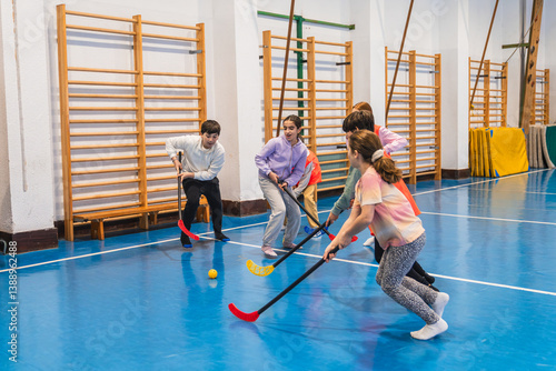 Принти на полотні Elementary school students enjoying a dynamic game of floorball during gym class