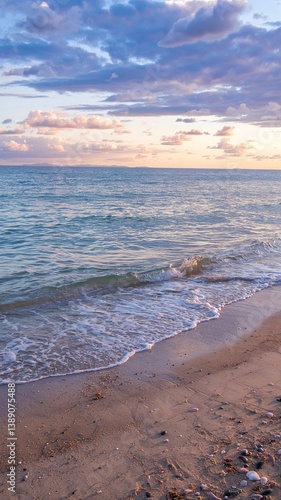 A stunning sea view with a sandy shore, showcasing a vibrant landscape with vivid colors. Tranquil waves meet golden sands under a breathtaking sky, perfect for travel and nature themes. 