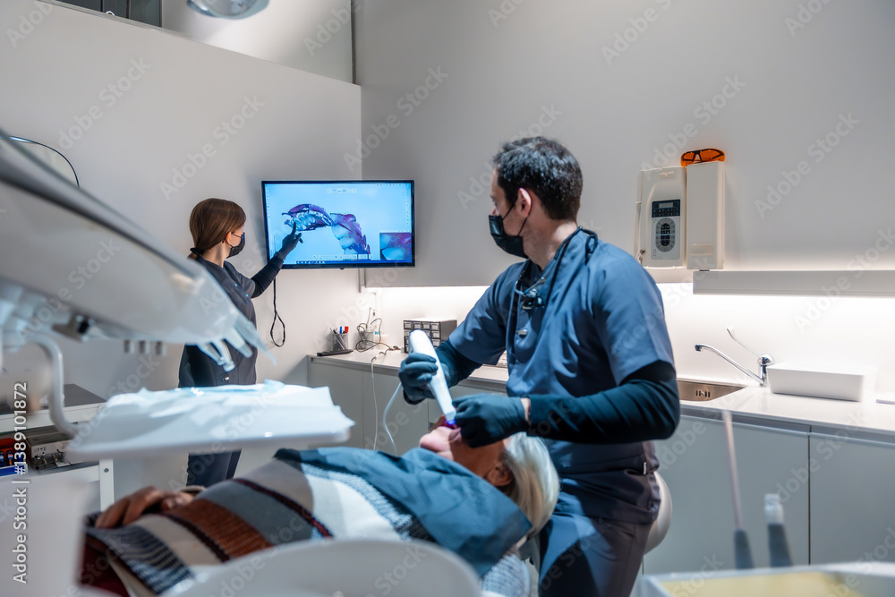 Dentists showing teeth x ray to patient during treatment in modern clinic