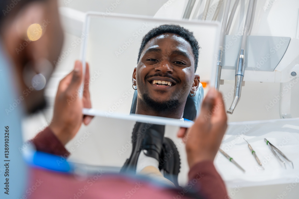 Patient admiring teeth whitening results in dental clinic mirror