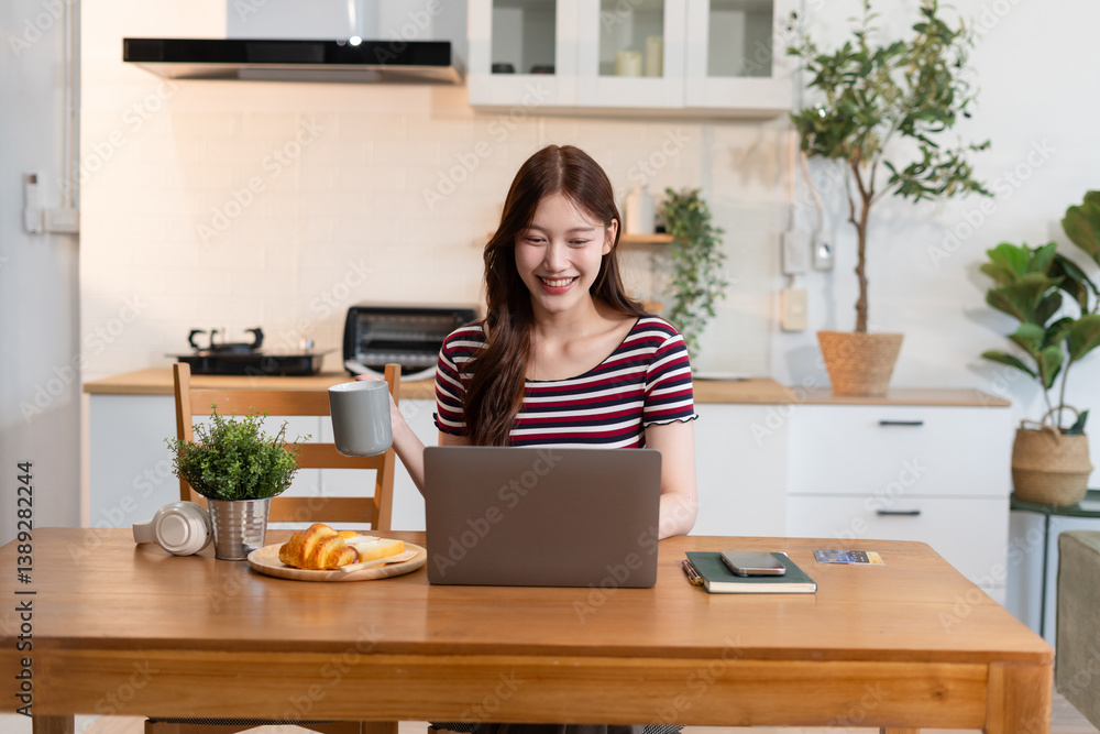 Lifestyle people, using computer working online, doing searching, sitting in the kitchen. Happy woman, entrepreneur, small business owner working online at home office. Lifestyle people, using computer working online, doing searching, sitting in the kitchen. Happy woman, entrepreneur, small business owner working online at home office.