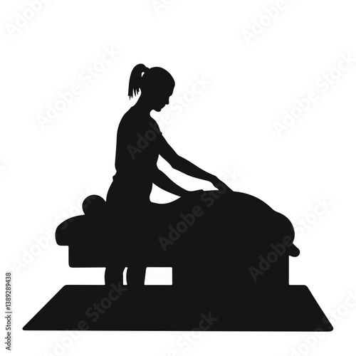 Massage therapist performing a massage on a client silhouette  