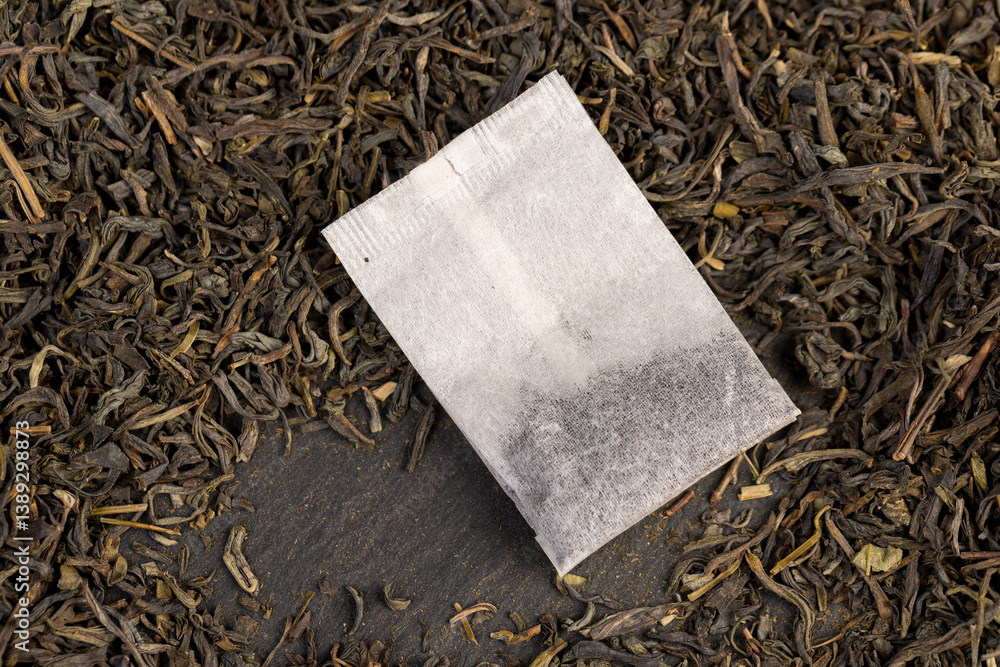 tea and packaged tea, high quality expensive green tea and a white bag with one cheap tea close up