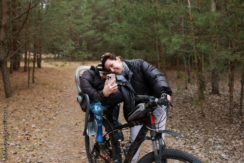 Obraz na płótnie Family enjoys a joyful bike ride through the woods on a sunny afternoon while capturing a selfie together w salonie