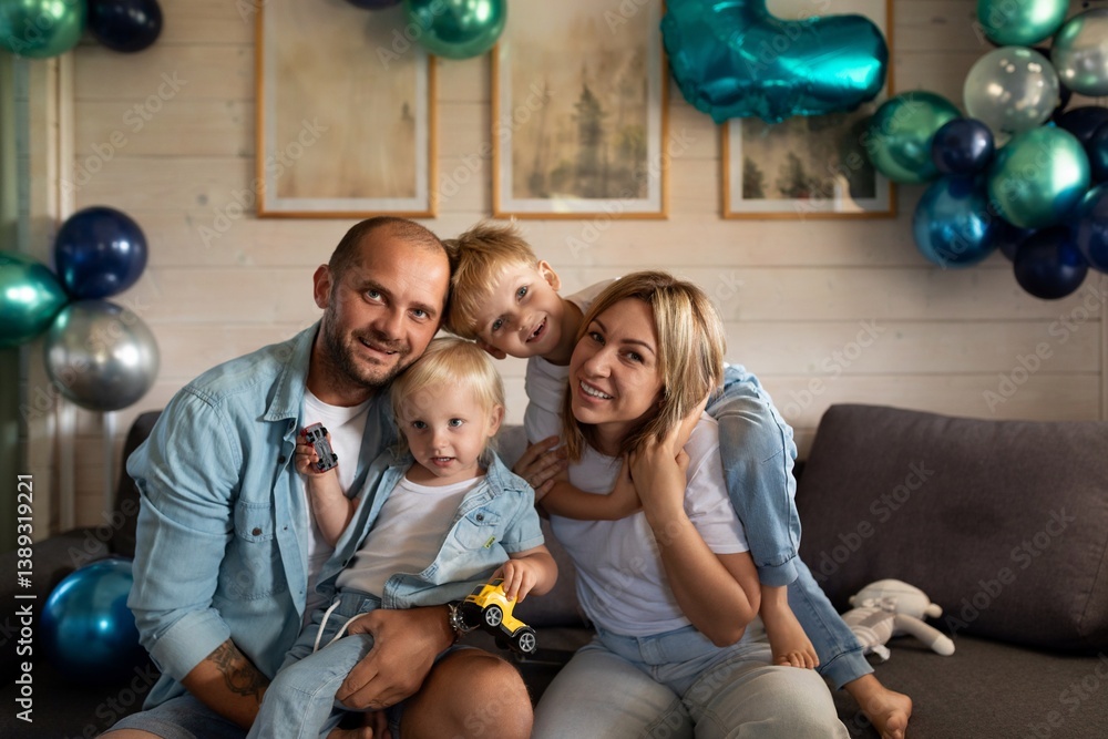Family celebration with children at home decorated with balloons in blue and green colors