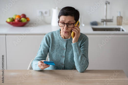 Tableau sur toile Anxious scared vulnerable woman sending money from accounts to fraudsters on phone