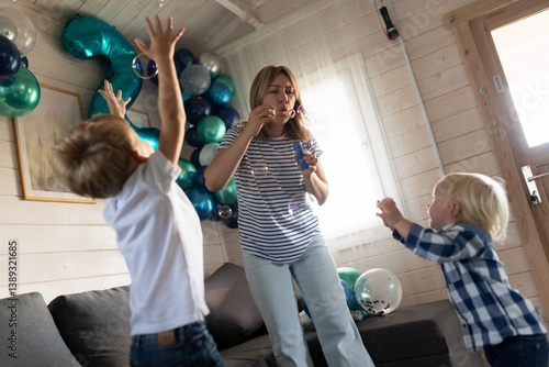 Celebration with children playing and enjoying bubbles indoors at a cozy party venue