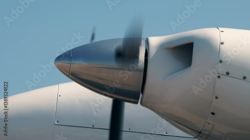 Close-up view of rotating propeller engine of twin turbo light airplane. Side view of spinning blades