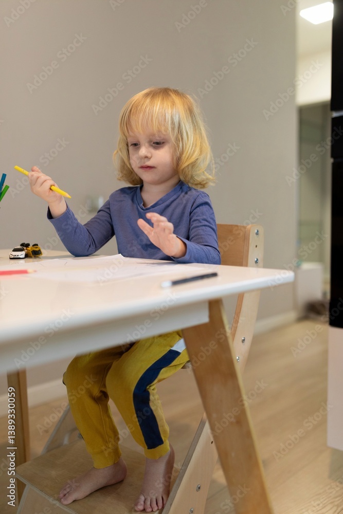 Child engaged in creative drawing activity at home during the afternoon