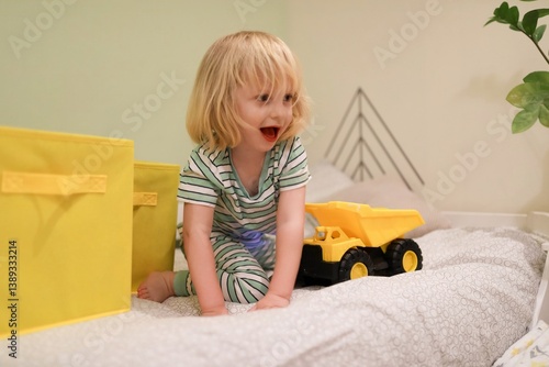 Obraz na płótnie Child playing joyfully with a toy truck in a colorful playroom during the afternoon w salonie
