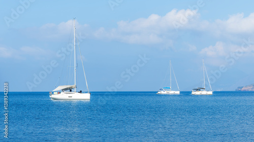 sailing yacht boats with white sails in blue sea , seascape of beautiful ships in sea gulf with mountain coast on background