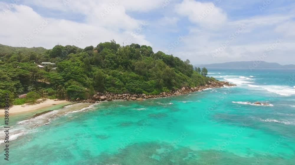 Praslin Beach, Seychelles. Aerial view of tropical coastline on a sunny day Praslin Beach, Seychelles. Aerial view of tropical coastline on a sunny day