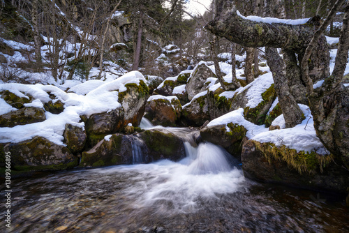 Mountain river waterfall in snow. Snowy river waterfall