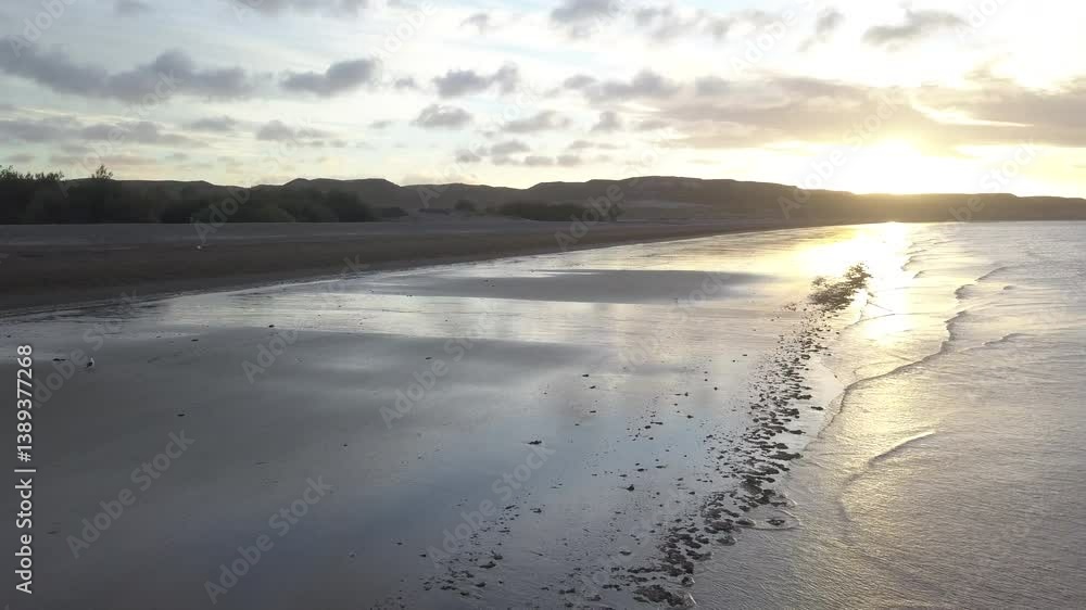 Drone panning over the beach at sunset Drone panning over the beach at sunset