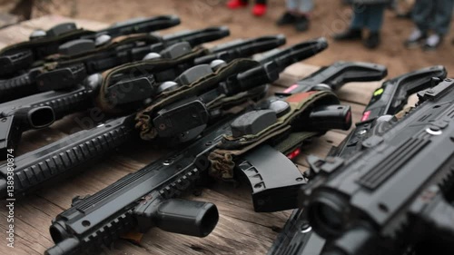 Closeup view of military rifles with ammunition on table in tactical setup, weaponry concept