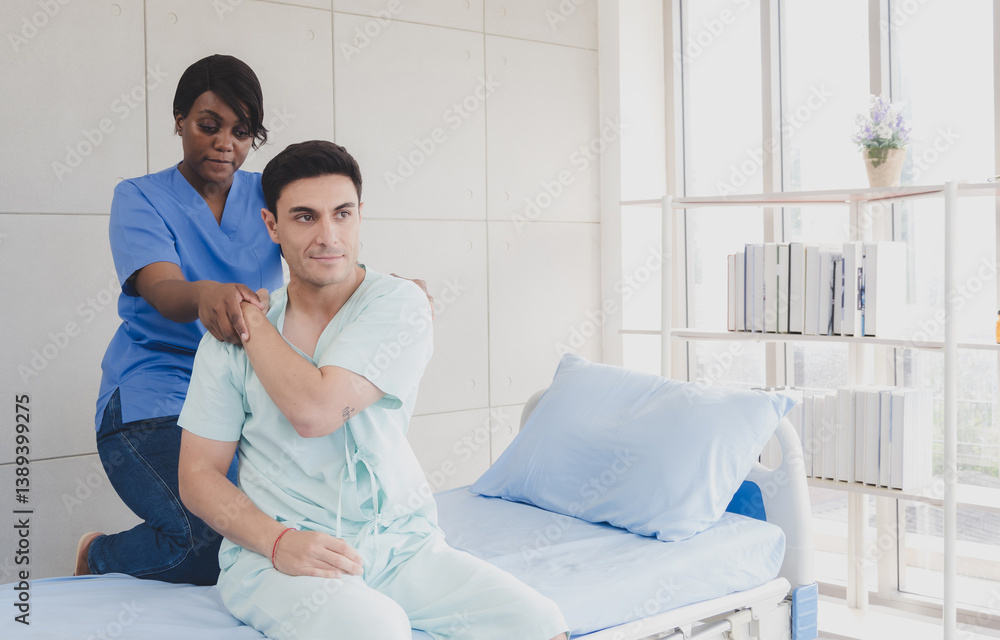 Obraz premium Patient caucasian man with woman nurse black people carer physical therapist two person sitting talk helping support give advice and holding relax massage on back body in room service hospital clinic