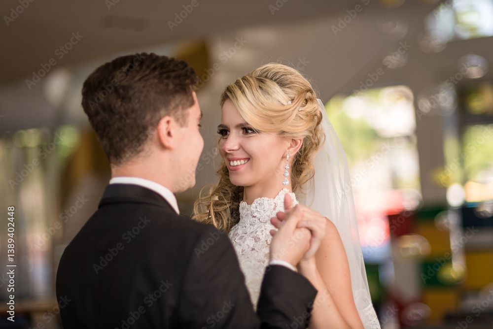 Bride and groom in a luxurious hotel lobby posing for a photographer, photo shoot in wedding dresses. Newlyweds, wedding couple in the interior, photo studio Bride and groom in a luxurious hotel lobby posing for a photographer, photo shoot in wedding dresses. Newlyweds, wedding couple in the interior, photo studio