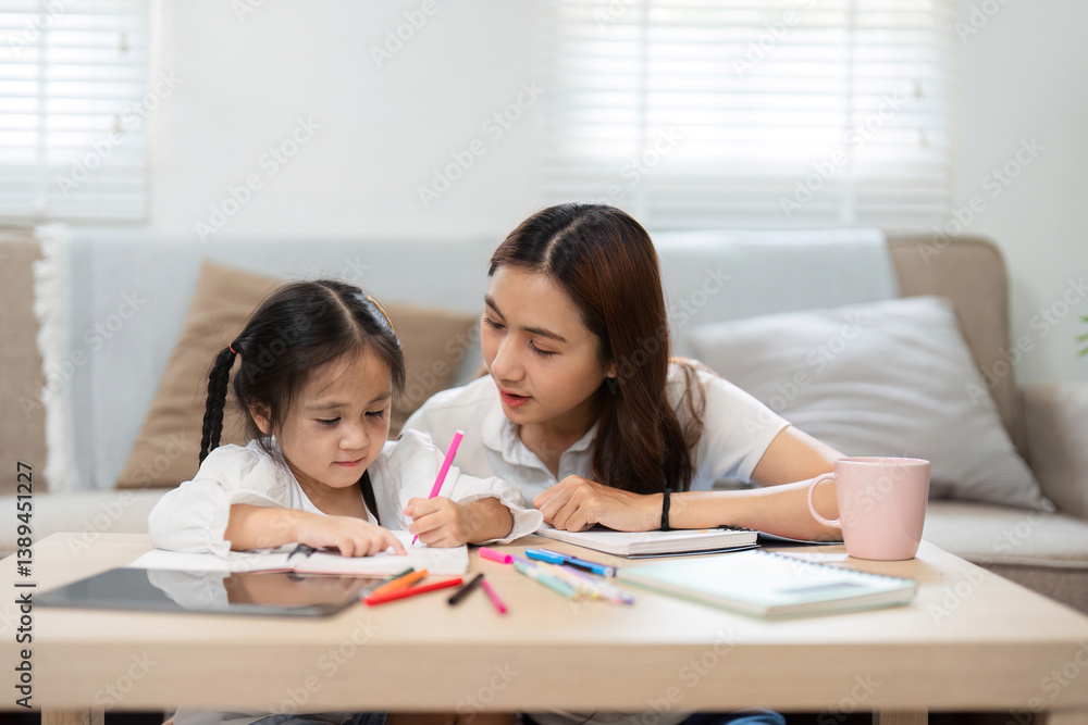 Creative Learning and Parental Support. A child draws while her mother provides guidance, creating a loving atmosphere for education. Creative Learning and Parental Support. A child draws while her mother provides guidance, creating a loving atmosphere for education.