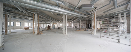Spacious office interior under renovation with industrial ducts