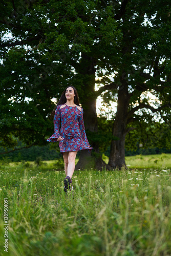 Obraz na płótnie Woman in floral dress standing in summer meadow......... w salonie