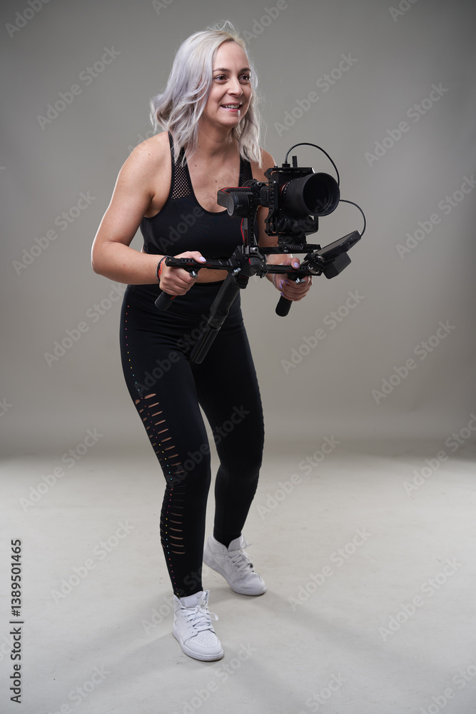 Woman filming with camera rig.........