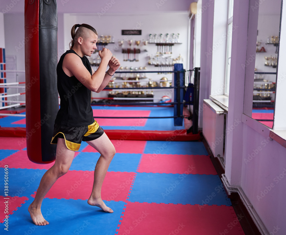 Kickboxer training inside martial arts gym.........
