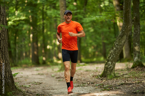 Obraz na płótnie Man running on forest path......... w salonie