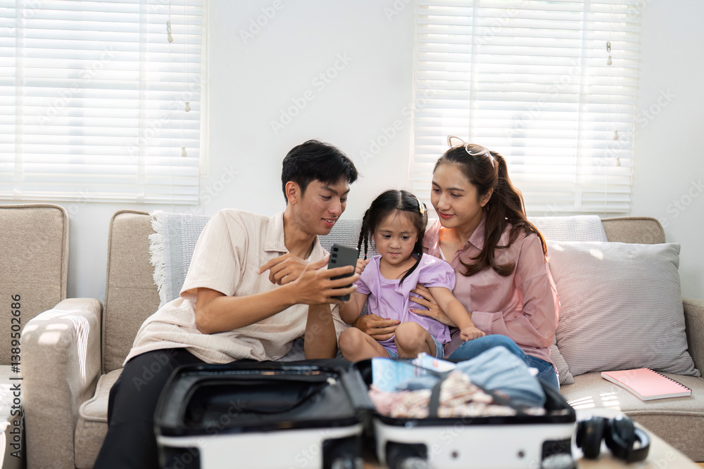 Family Preparation and Packing. Parents assist their daughter in organizing a suitcase, preparing for an upcoming family trip. Family Preparation and Packing. Parents assist their daughter in organizing a suitcase, preparing for an upcoming family trip.