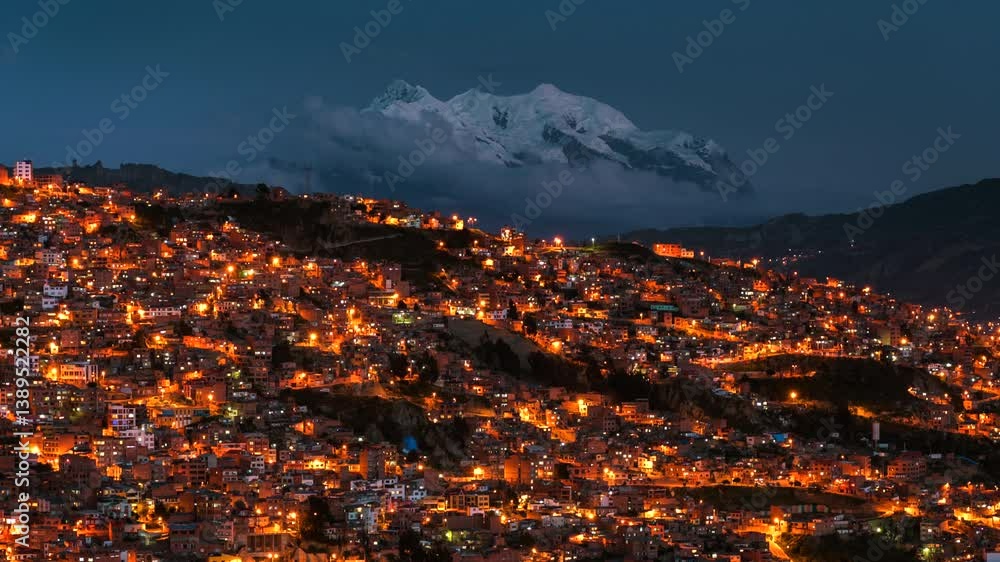 Day to night timelapse of La Paz cityscape and Illimani mountain in Bolivia, South America.