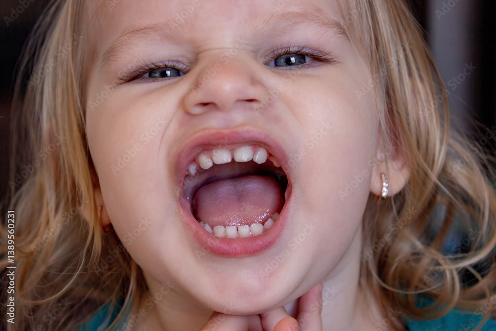 Beautiful and healthy baby teeth in a little girl. The baby's mouth with a milk tooth Beautiful and healthy baby teeth in a little girl. The baby's mouth with a milk tooth