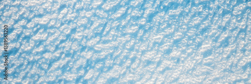 Obraz na płótnie Beautiful winter background with snowy ground. Natural snow texture. Wind sculpted patterns on snow surface. Wide panoramic texture for background and design. w salonie