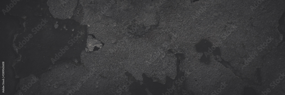 Dark wide panoramic background. Peeling paint on a concrete wall. Faded dark texture of old cracked flaking paint. Weathered rough painted surface with patterns of cracks. Shaded background for design