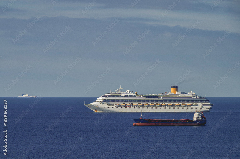 Mega family cruiseship cruise ship liner Favolosa and bunker ship anchored offshore of Civitavecchia Rome, Italy before reactived after Covid pandemic with other vessels in port and coastline