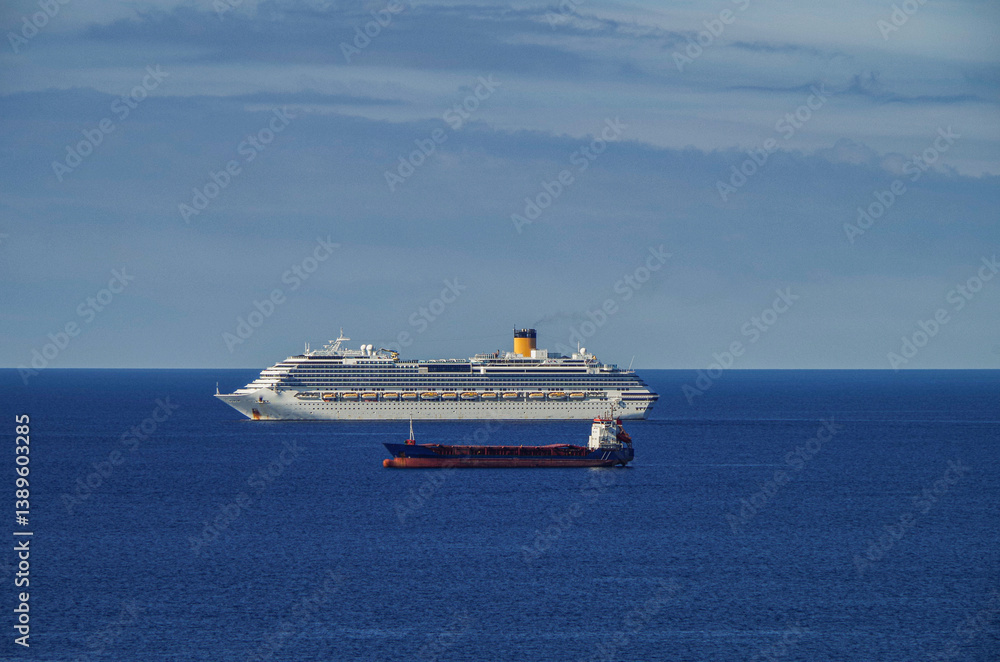 Mega family cruiseship cruise ship liner Favolosa and bunker ship anchored offshore of Civitavecchia Rome, Italy before reactived after Covid pandemic with other vessels in port and coastline