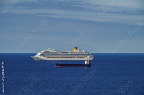 Obraz na płótnie Mega family cruiseship cruise ship liner Favolosa and bunker ship anchored offshore of Civitavecchia Rome, Italy before reactived after Covid pandemic with other vessels in port and coastline w salonie