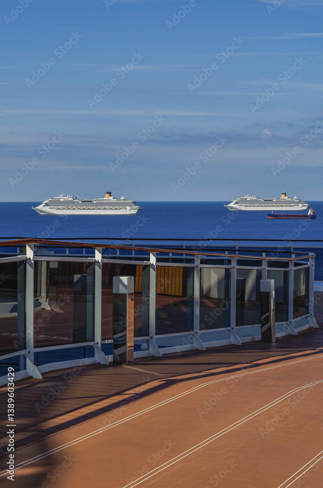 Mega family cruiseship cruise ship liner Favolosa and Fortuna anchored offshore of Civitavecchia Rome, Italy before reactived after Covid pandemic with other vessels in port and coastline