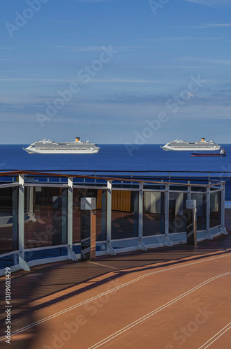 Obraz na płótnie Mega family cruiseship cruise ship liner Favolosa and Fortuna anchored offshore of Civitavecchia Rome, Italy before reactived after Covid pandemic with other vessels in port and coastline w salonie