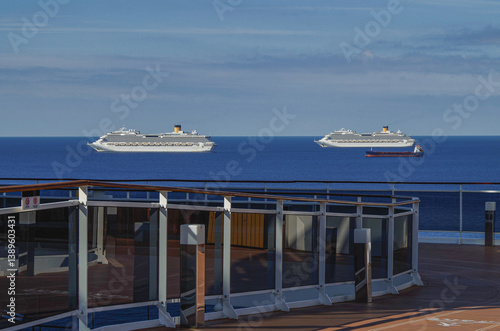 Mega family cruiseship cruise ship liner Favolosa and Fortuna anchored offshore of Civitavecchia Rome, Italy before reactived after Covid pandemic with other vessels in port and coastline