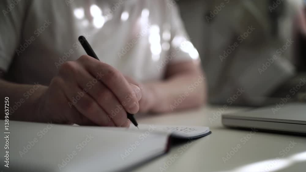 Man’s Hand Holding a Pen While Writing on a Notebook. Journaling his thoughts into notebook, because he has some sort of depression Man’s Hand Holding a Pen While Writing on a Notebook. Journaling his thoughts into notebook, because he has some sort of depression