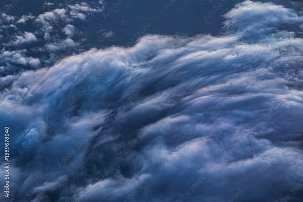 Mountains blanketed in clouds, aerial view