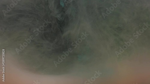 Slow motion yellow and pink ink acrylic paint mixing in water, swirling softly underwater. Colored acrylic cloud of paint isolated. Abstract smoke explosion animation. Beautiful art background