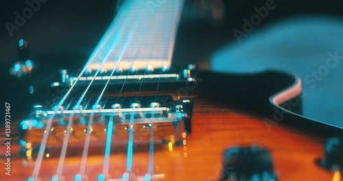 Close-Up of an Electric Guitar. Details of strings, frets, and the body shine under moody lighting. Music, creativity, and rock culture.