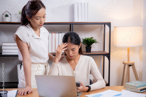 Two young asian businesswoman working on laptop and tablet with worried and stress, mistake and upset of business, mental health, unhappy of business woman with disappointed, business and distraught.