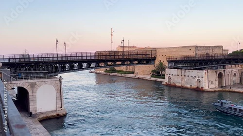 SWING BRIDGE, IN MOTION, WITH BOTH ARMS CLOSING.