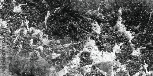 The abstract and visually dynamic interplay of light and shadow across a deeply textured surface in monochrome.
