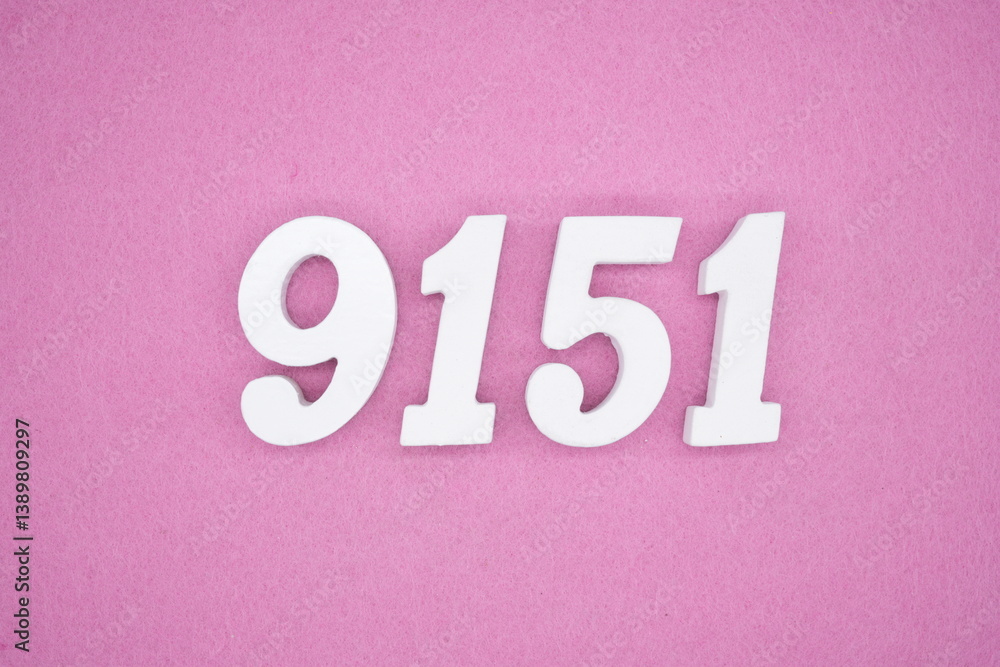 The numbers are made of white painted wood and placed on a pink paper background. The numbers are made of white painted wood and placed on a pink paper background.