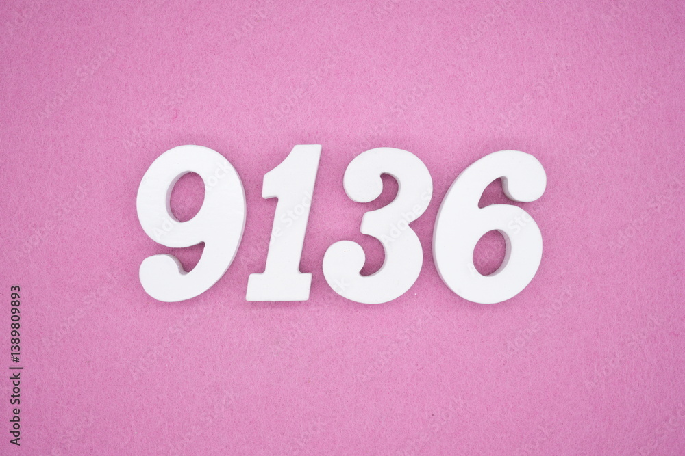 The numbers are made of white painted wood and placed on a pink paper background. The numbers are made of white painted wood and placed on a pink paper background.