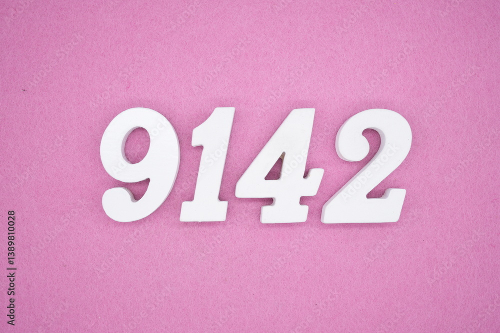 The numbers are made of white painted wood and placed on a pink paper background. The numbers are made of white painted wood and placed on a pink paper background.